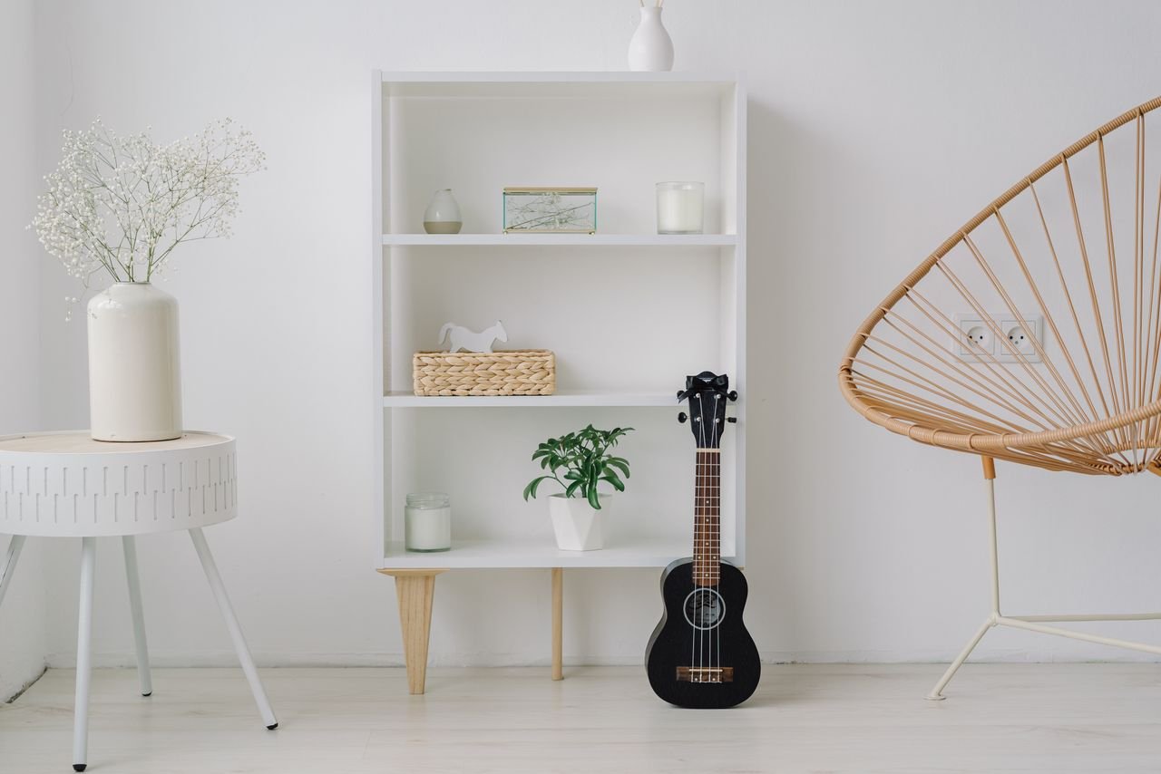 Crafting Captivating Headlines: Your awesome post title goes here A modern minimalist living room setup featuring a ukelele, shelves, and stylish decor.