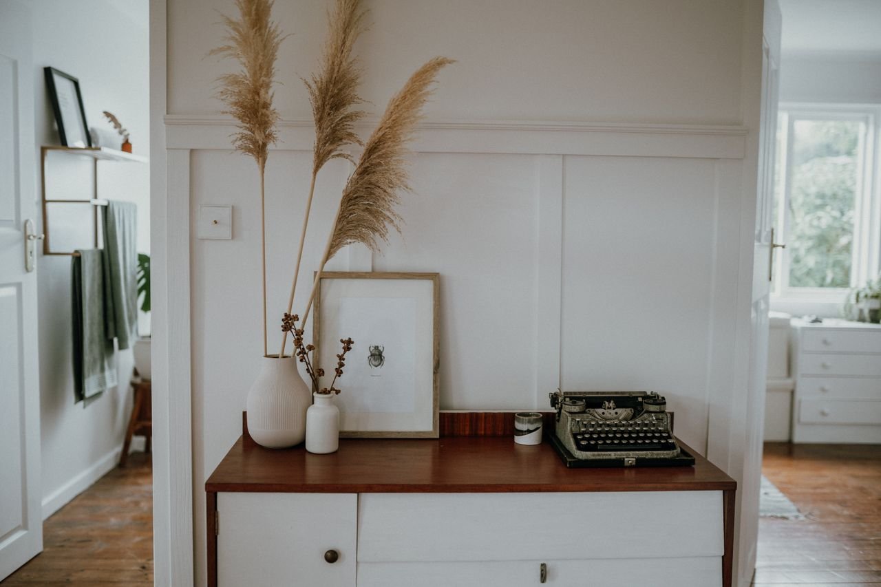 The Art of Drawing Readers In: Your attractive post title goes here Elegant Scandinavian interior with pampas grass and vintage typewriter decor.